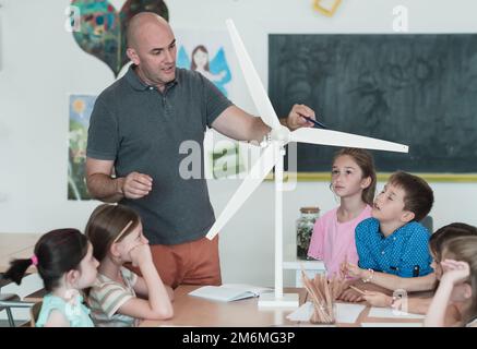 Elementary School Stem Robotics Classroom Diverse Group of Children Building and Programming windmill ecology robot concept. Tog Stock Photo