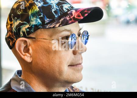 A man wearing indoor sunglasses due to light sensitivity Stock Photo