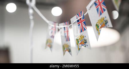 A garland of British Antarctic Territory national flags on an abstract blurred background. Stock Photo