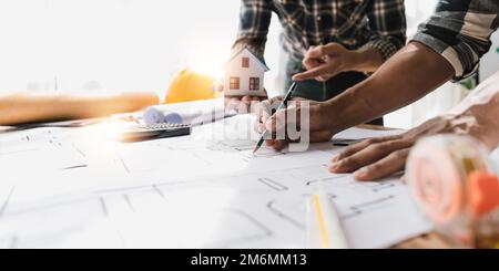 Architecture engineer teamwork meeting working for architectural project and engineering tools on workplace on blueprint, concept of work on technical Stock Photo