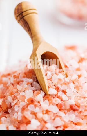 Pink himalayan salt in the wooden scoop. Stock Photo