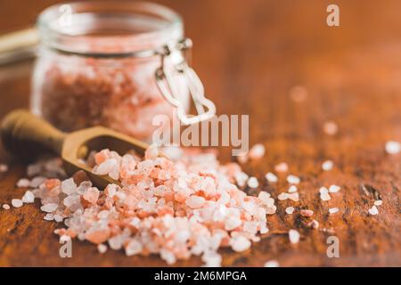 Pink himalayan salt on the wooden table. Stock Photo
