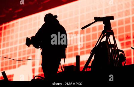 Cameraman silhouette in stage lights Stock Photo