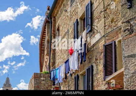 PIENZA, TUSCANY, ITALY - MAY 19 : Washing hanging from building in Pienza Italy on May 19, 2013 Stock Photo