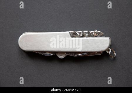 Metallic swiss knife isolated on black Stock Photo