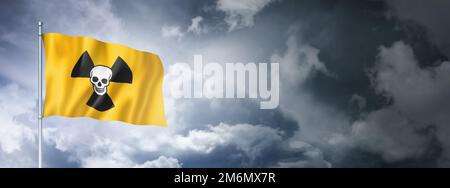 Radioactive nuclear symbol death flag on a cloudy sky Stock Photo