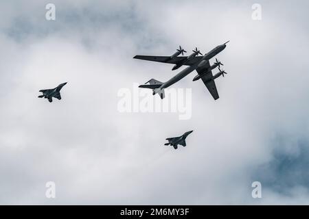 Russia, St. Petersburg, 28 July 2022: Military aircraft and helicopters of the air force fly on the city at the celebration of t Stock Photo