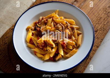 Macaroni with tomato, bacon and Japanese shitake mushrooms. Stock Photo