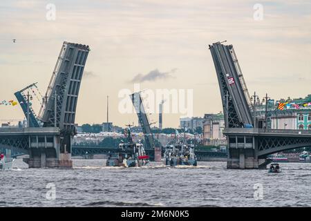 Russia, St. Petersburg, 31 July 2022: A lot of warships goes along the Neva River under open bridges at the celebration of the d Stock Photo