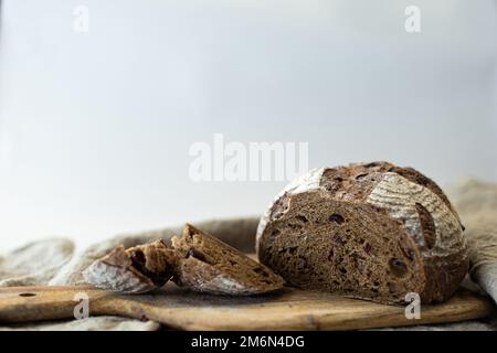black oval bread on a background, fresh pastries,sliced bread space for text Stock Photo