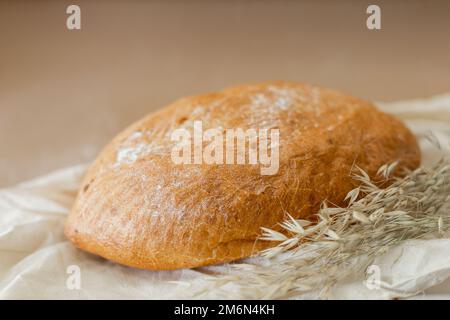 white bread lying on the board, photo in the style of rustic, on a beige background, a place for text Stock Photo