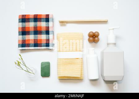 Bathroom spa products. shampoo, shower soap, towel, toothbrush on white background. flat lay, top view, copy space Stock Photo