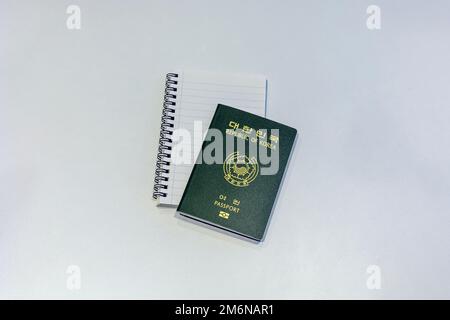 Republic of Korea passport with notebook on the white background Stock Photo