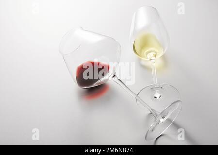 Little red, white wine is poured into stem glasses. Stock Photo