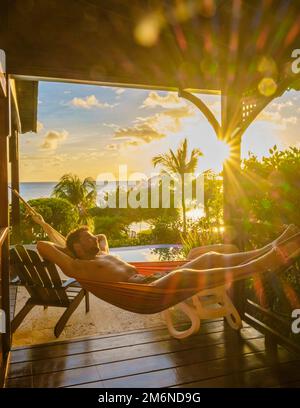 Young men in a swim short on the beach Miami with a bicycle, colorful