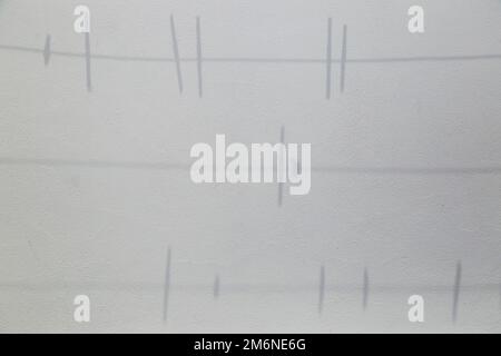 shadow on the wall of clothesline and clothespins Stock Photo