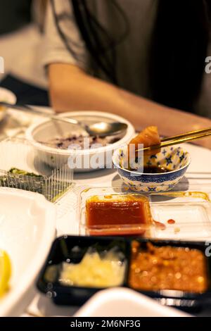 Eating seafood by dipping a soy sauce Stock Photo