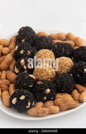 Indian Winter Delicacy Black Ball Shaped Kaala Tilgul Laddu Or Kale Til Ki Laddo Is Made Of Roasted Sesame Seed, Jaggery, Gur, Peanut, Gud, Mungfali I Stock Photo