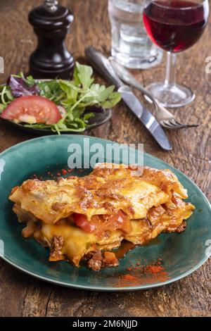 Italian lasagna on dark wood Stock Photo