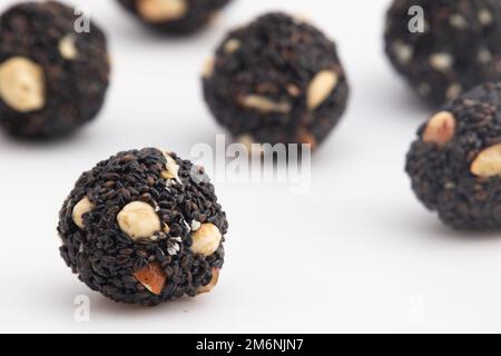 Indian Winter Delicacy Black Ball Shaped Kaala Tilgul Laddu Or Kale Til Ki Laddo Is Made Of Roasted Sesame Seed, Jaggery, Gur, Peanut, Gud, Mungfali I Stock Photo