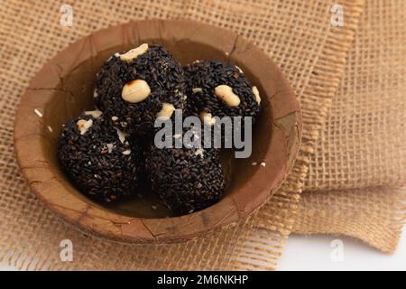 Indian Winter Delicacy Black Ball Shaped Kaala Tilgul Laddu Or Kale Til Ki Laddo Is Made Of Roasted Sesame Seed, Jaggery, Gur, Peanut, Gud, Mungfali I Stock Photo