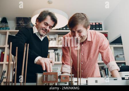 Architects with blueprints and layout design project at office Stock Photo