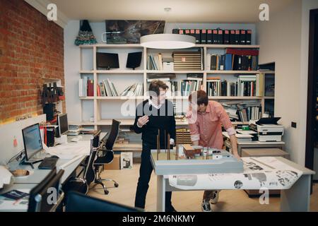 Architect with blueprints and layout design project at office Stock Photo
