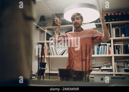 Architect with blueprints and layout design project at office Stock Photo