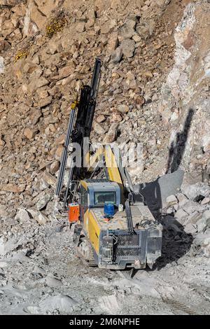 Drilling machine in open cast mining quarry Stock Photo