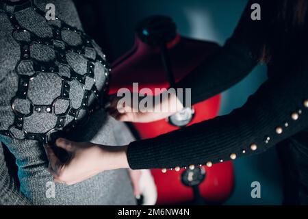 Tanner woman making leather goods on workshop. Working process of leather craftsman Stock Photo