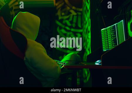 Hacker using computer malware software and hacking binary code digital interface. Stock Photo