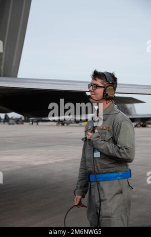 A U.S. Air Force crew chief with the 192nd Fighter Wing, Virginia Air National Guard,  communicates with a  F-22 Raptor pilot prior to launch May 3, 2022, at the Air Dominance Center, Combat Readiness Training. Center, in Savannah, Georgia. Sentry Savannah 2022 is the Air National Guard’s premier counter air exercise, encompassing 10 units of fourth and fifth generation fighter aircraft, which tests the capabilities of our warfighters in a simulated near-peer environment and trains the next generation of fighter pilots for tomorrow’s fight. Stock Photo
