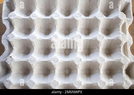 Top view of an empty cardboard egg tray. Background texture of a container made of biodegradable paper packaging with a repeatin Stock Photo