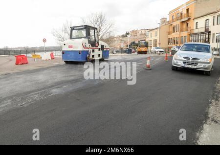 Machines performing asphalting and paving work on a city road. Stock Photo