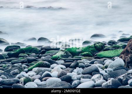 Pebbles on the shore in the sea Stock Photo