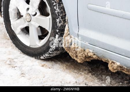 Closeup of car tires in winter on the road covered with snow Stock Photo