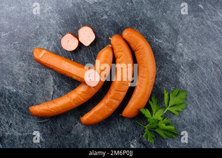 Traditional raw German bockwurst offered as top view on a gray board with copy space Stock Photo