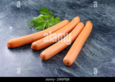 Traditional raw German bockwurst offered as close-up on gray background with copy space Stock Photo