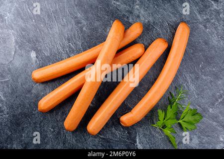 Traditional raw German bockwurst offered as top view on a gray board with copy space Stock Photo