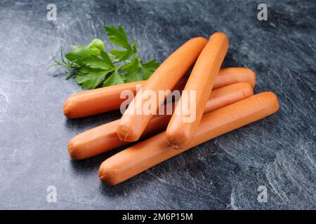 Traditional raw German bockwurst offered as close-up on a gray board with copy space Stock Photo