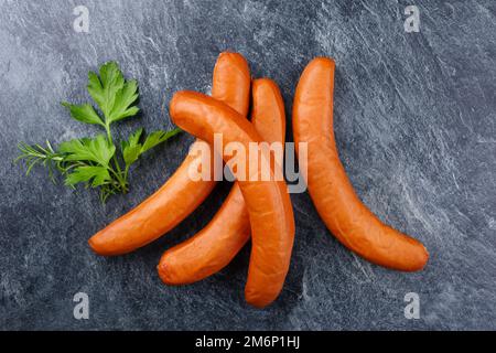 Traditional raw German bockwurst offered as top view on a gray background with copy space Stock Photo