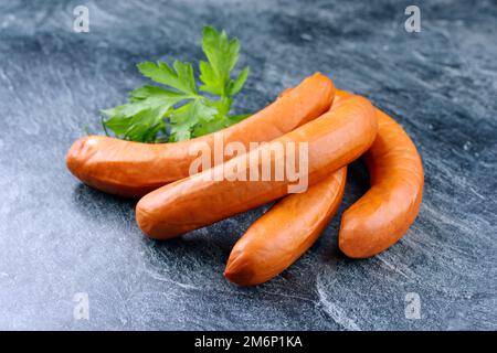 Traditional raw German bockwurst offered as close-up on white background with copy space Stock Photo