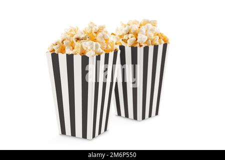 Two black white striped carton buckets with tasty cheese popcorn, isolated on white background. Movies, cinema and entertainment concept. Stock Photo