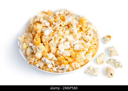 Tasty cheese popcorn in bowl isolated on white background close up. Movies, cinema and entertainment concept. Stock Photo