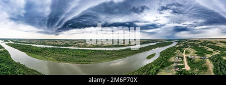 A panoramic shot of the North Saskatchewan River under the gloomy sky Stock Photo