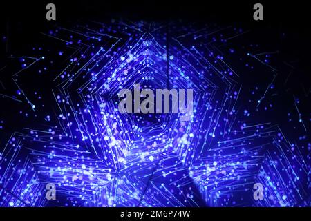 Blue kaleidoscope ornament. Carousel kaleidoscope. Bright neon pattern on a dark background. Horizontal blurry picture Stock Photo