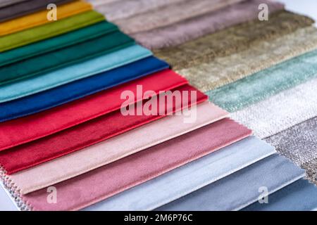 Bright collection of colorful textile samples. Fabric swatches, set in different colors for selection. Variety colors of upholstery material for furni Stock Photo