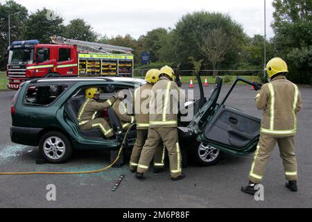 Dreghorn, Ayrshire, Scotland, UK : Firefighters from Scottish Fire & Rescue demonstrate taking a car roof off in front of secondary school pupils Stock Photo
