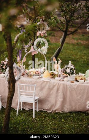 A vertical shot of the beautiful Easter table with egg cakes and decorations Stock Photo