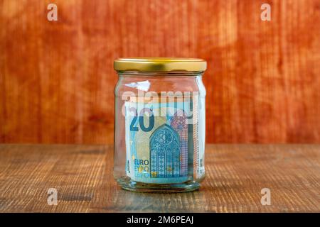 Money saving in glass jar with Euros inside Stock Photo